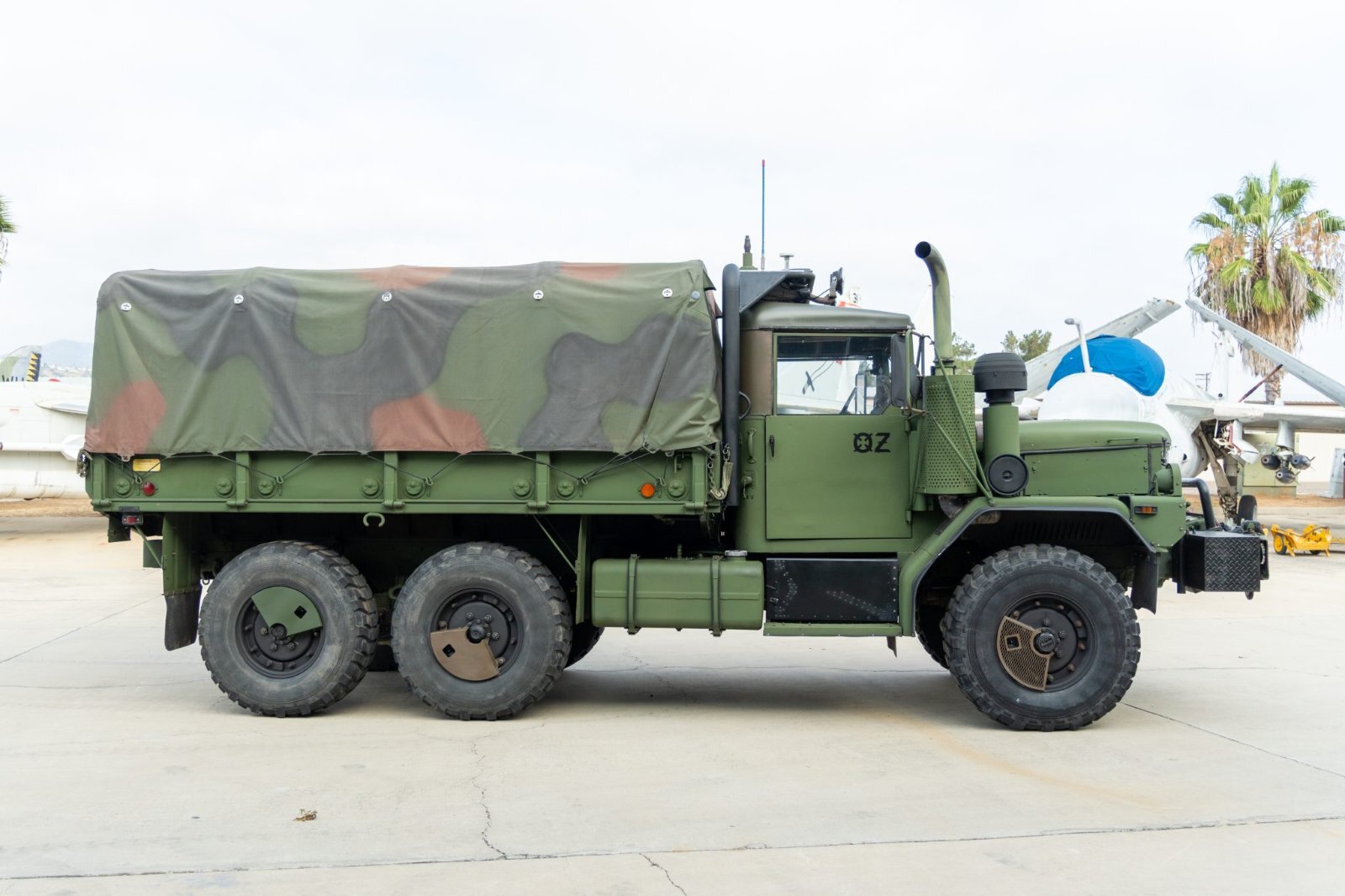 AM General M35A3 deuce and a half side profile with camouflage cargo cover